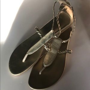 Women’s Cole Haan gold flat sandal.